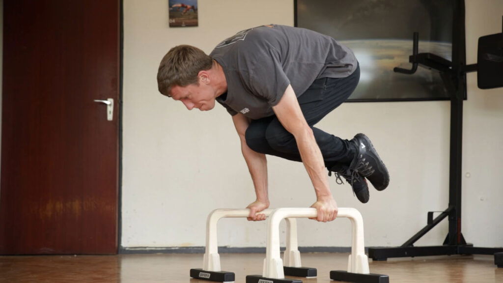 Jelle doing a tuck planche on Gorletic medium parallettes