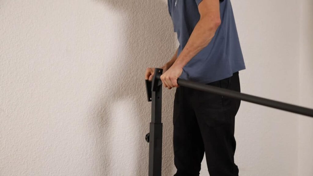 The top bar of the Gravity Fitness Static Bar being attached to an adjustable vertical post using a back plate and bolts.