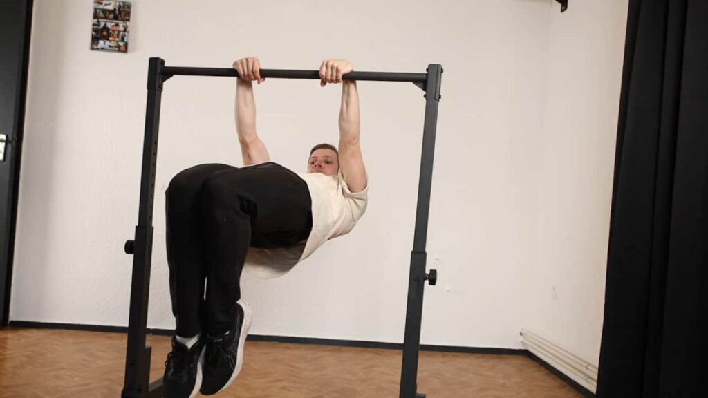 Man in beige tshirt performing a Front Lever under the Gravity Fitness Static Bar.