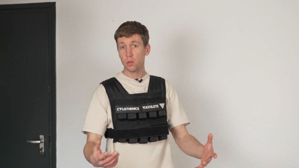 Man in white shirt wearing the 20kg GORNATION Weighted Vest with custom Calisthenics Athlete branding badges on the front of the vest.