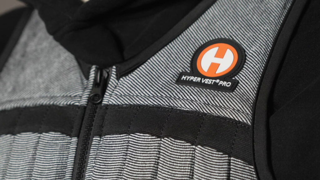 Close up of the Hyperwear Hyper Vest focussing on the orange logo and zipper.