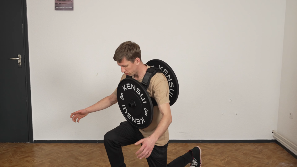 Man performing successful lunges while wearing a Kensui EZ Vest plate loaded weight vest.