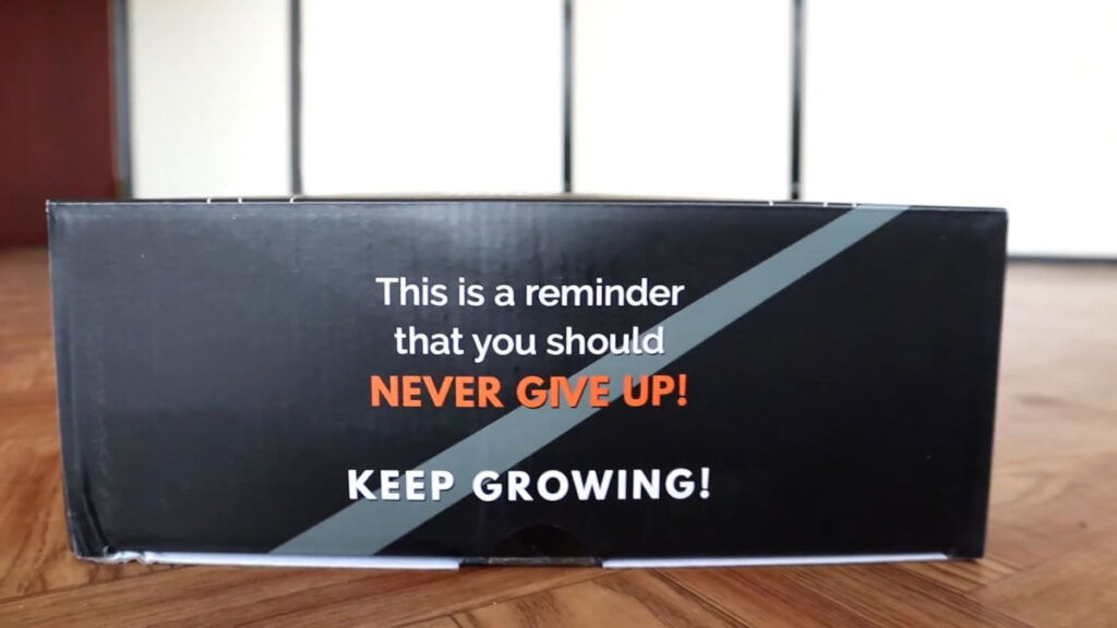 Side view of the box for the Gornation Gymnastic Rings with the slogans "This is a reminder that you should never give up" and "keep growing" printed on it.