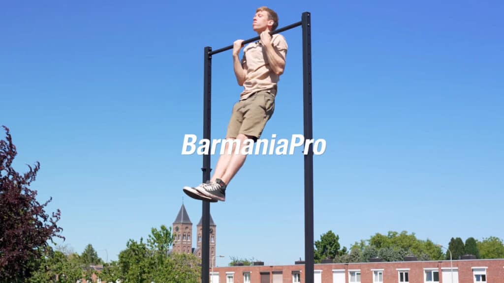 Man in beige shirt doing a chin-up on the BarMania Pro Free-Standing Pull-Up Bar