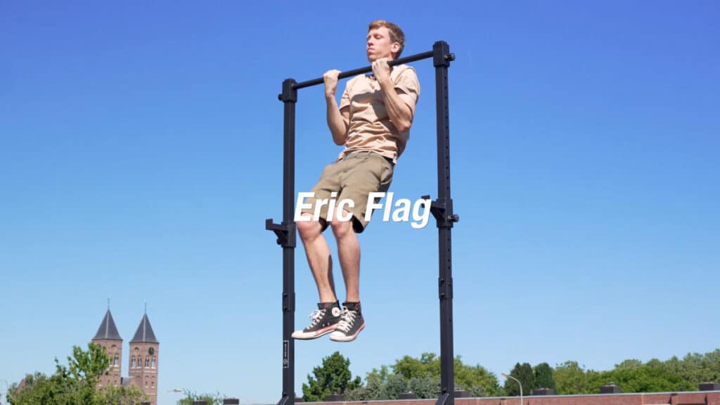 Man in beige shirt doing a chin-up on the Eric Flag Free-Standing Pull-Up Bar