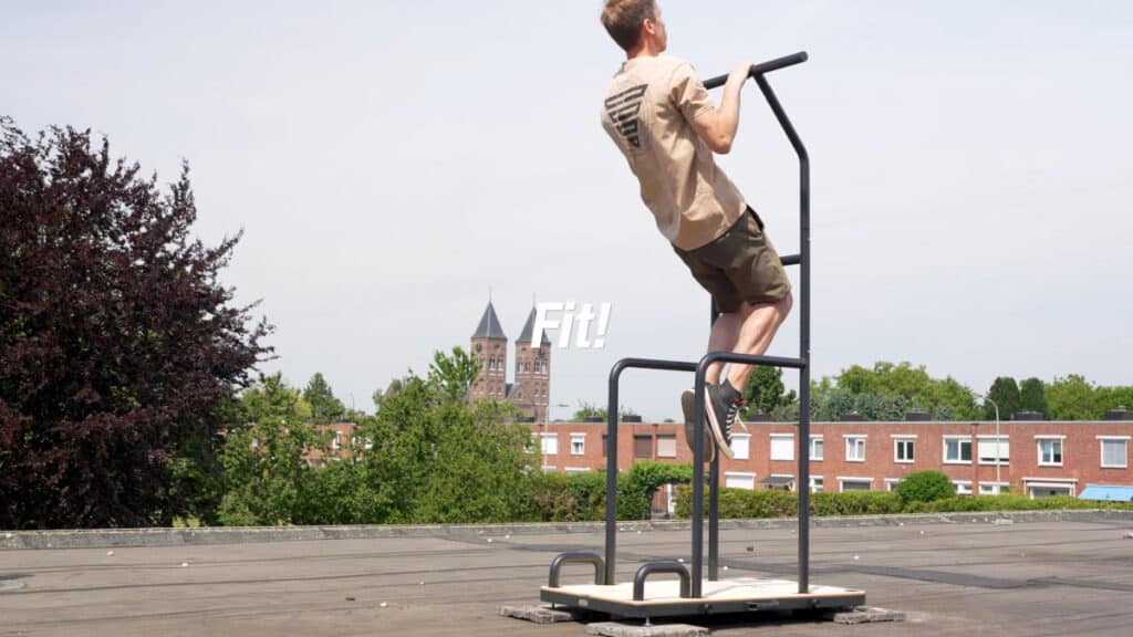 Man in beige shirt doing pull-ups on the Fit! Free-Standing Pull-Up Bar.