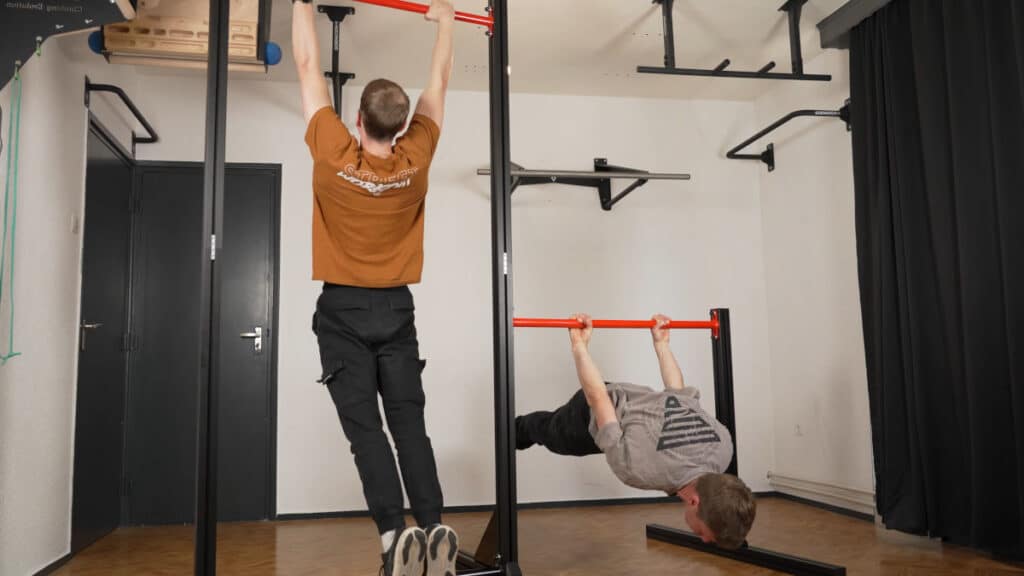 Two men exercising on the FitnessKit Modular Pull-Up Bar and Static Bar modules.