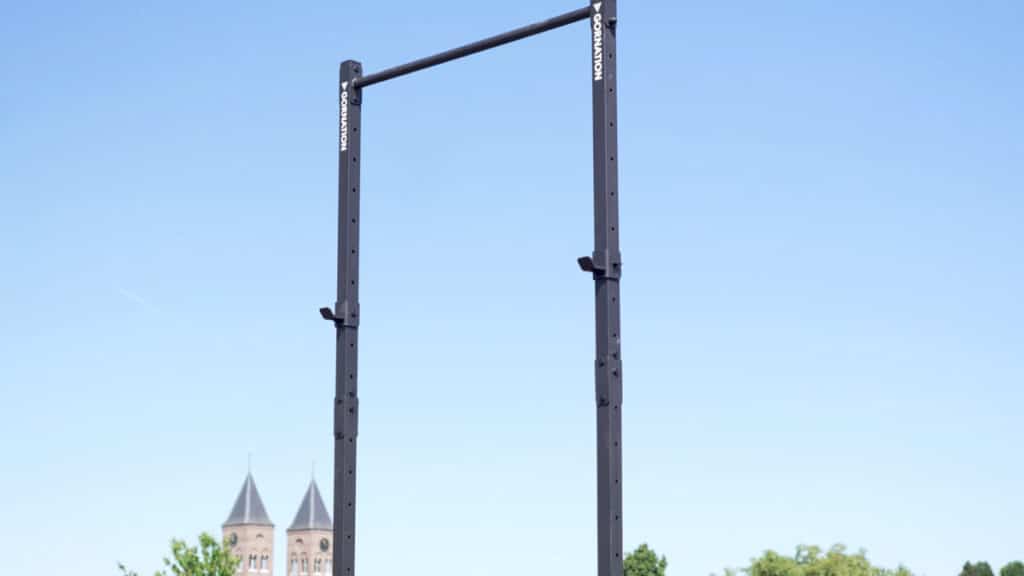 Wide shot of the Gornation Pull-Up Station Free-Standing Pull-Up Bar with a double bell tower church in the background.
