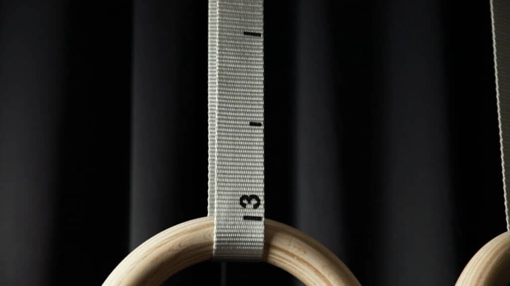 Close up of the straps of the Gorletic Gymnastic Rings with the rings just visible suspended from it and the number 3 marking visible.