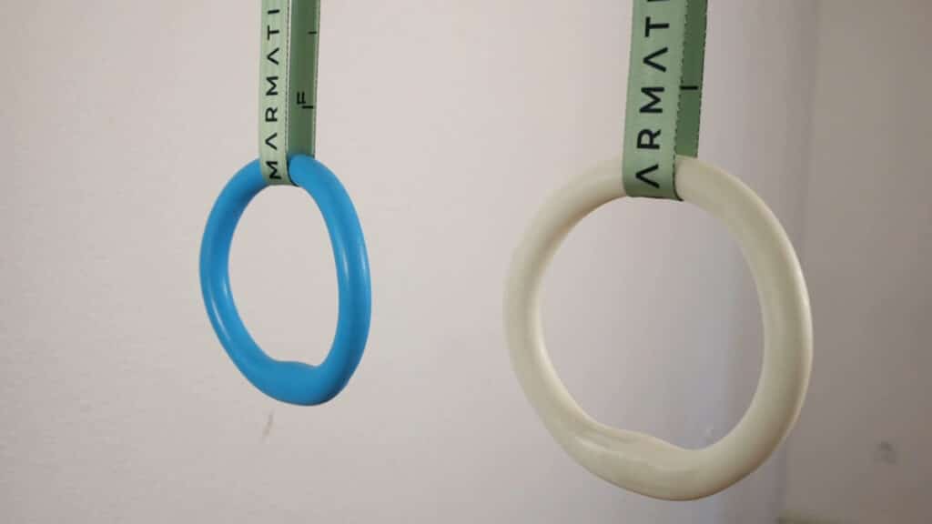The white prototype and blue final version Infinity Rings hanging side by side on a set of Marmati straps.