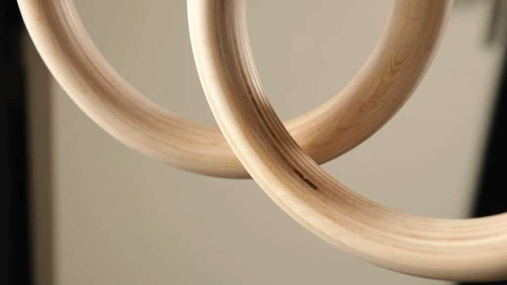 Close up of two Pullup & Dip Gymnastic Rings showing the grain of the birch wood laminate.