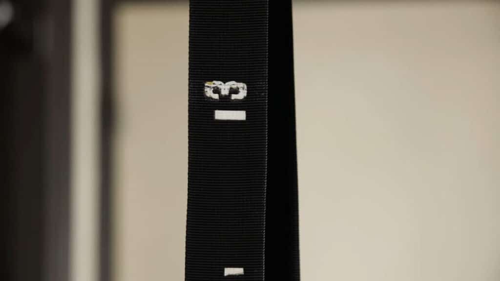Close up of the straps of the Pullup & Dip Gymnastic Rings showing the faded markings and their low quality.