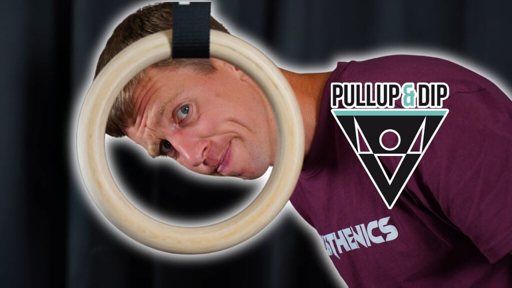 Man in purple shirt looking at the viewer through one of the Pullup & Dip Gymnastic Rings.