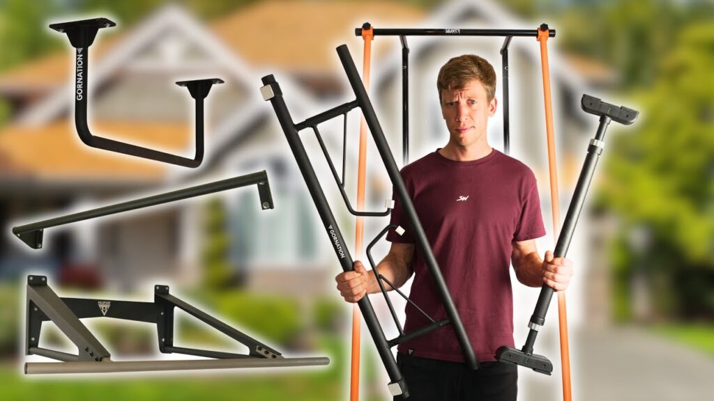 Man in purple shirt holding various home Pull-Up Bars and looking inquisitively at the viewer.