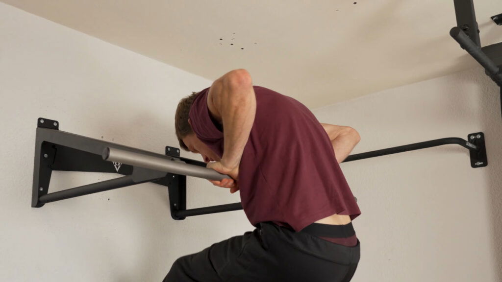 Man in purple shirt doing a Muscle-Up on the Pullup & Dip Muscle-Up Bar.