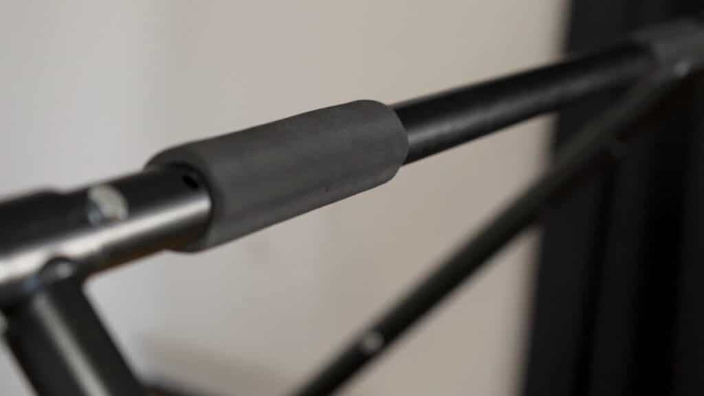 Close up of one of the foam grips on the Khanh Trinh Pull-Up Bar showing its thin profile and firmness.