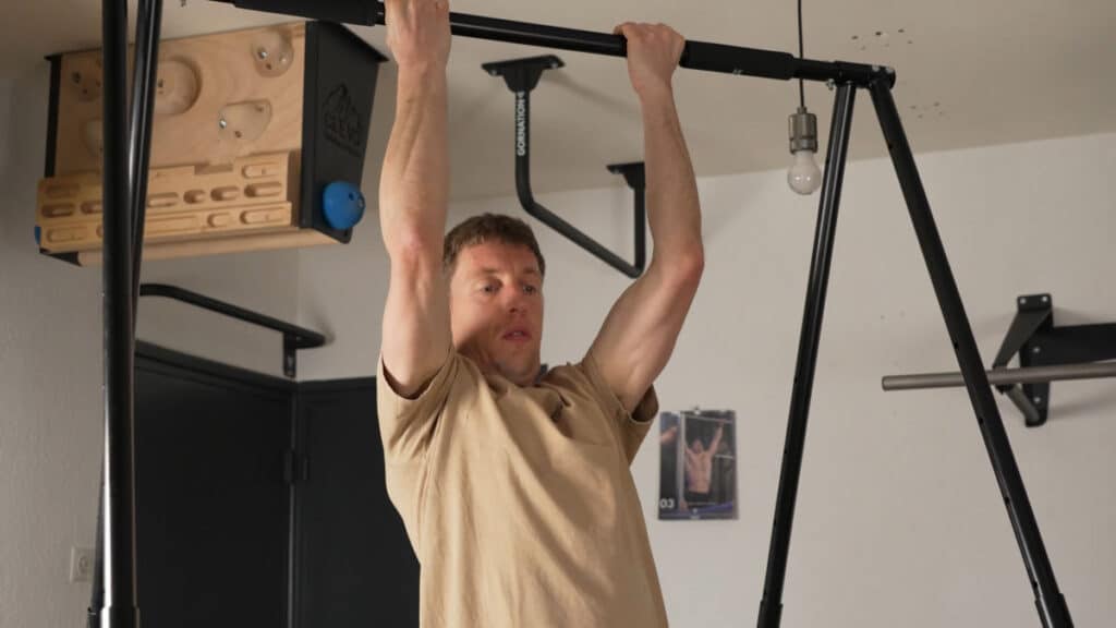 Man in beige shirt doing normal Chin-Ups on the Khanh Trinh Pull-Up Bar.