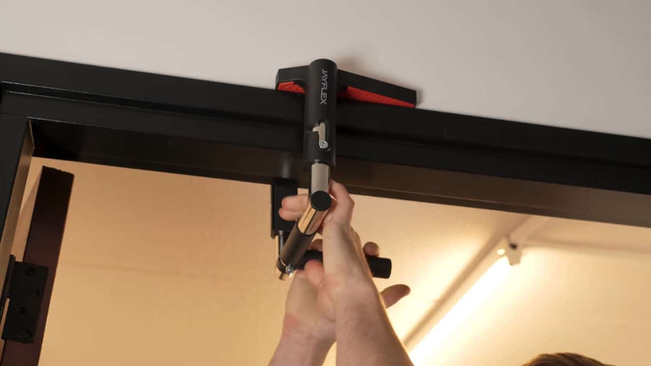 Man making adjustments to the Jayflex CrossGrips door pull-up handles.