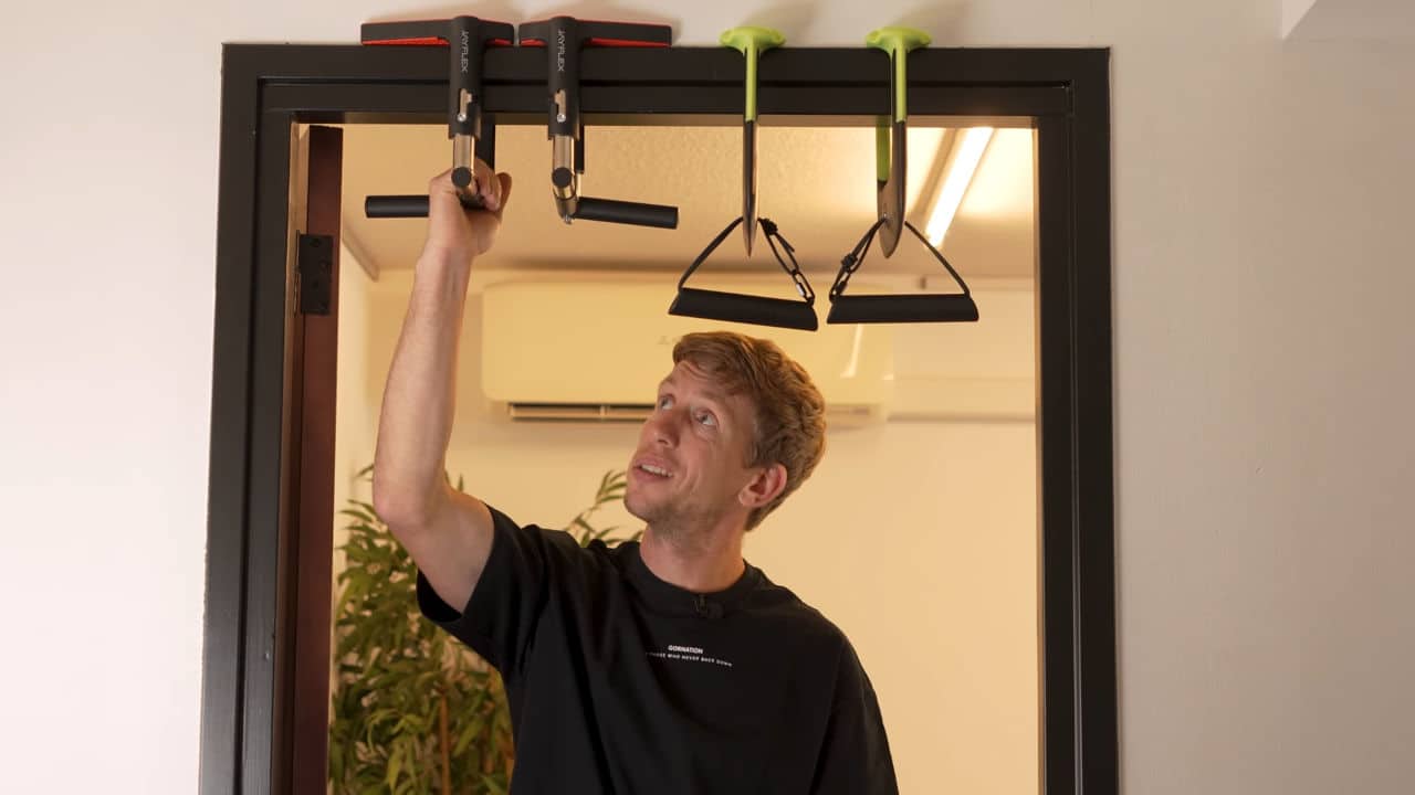 Man inspecting the limited space for hand placement on the Jayflex CrossGrips door pull-up handles.