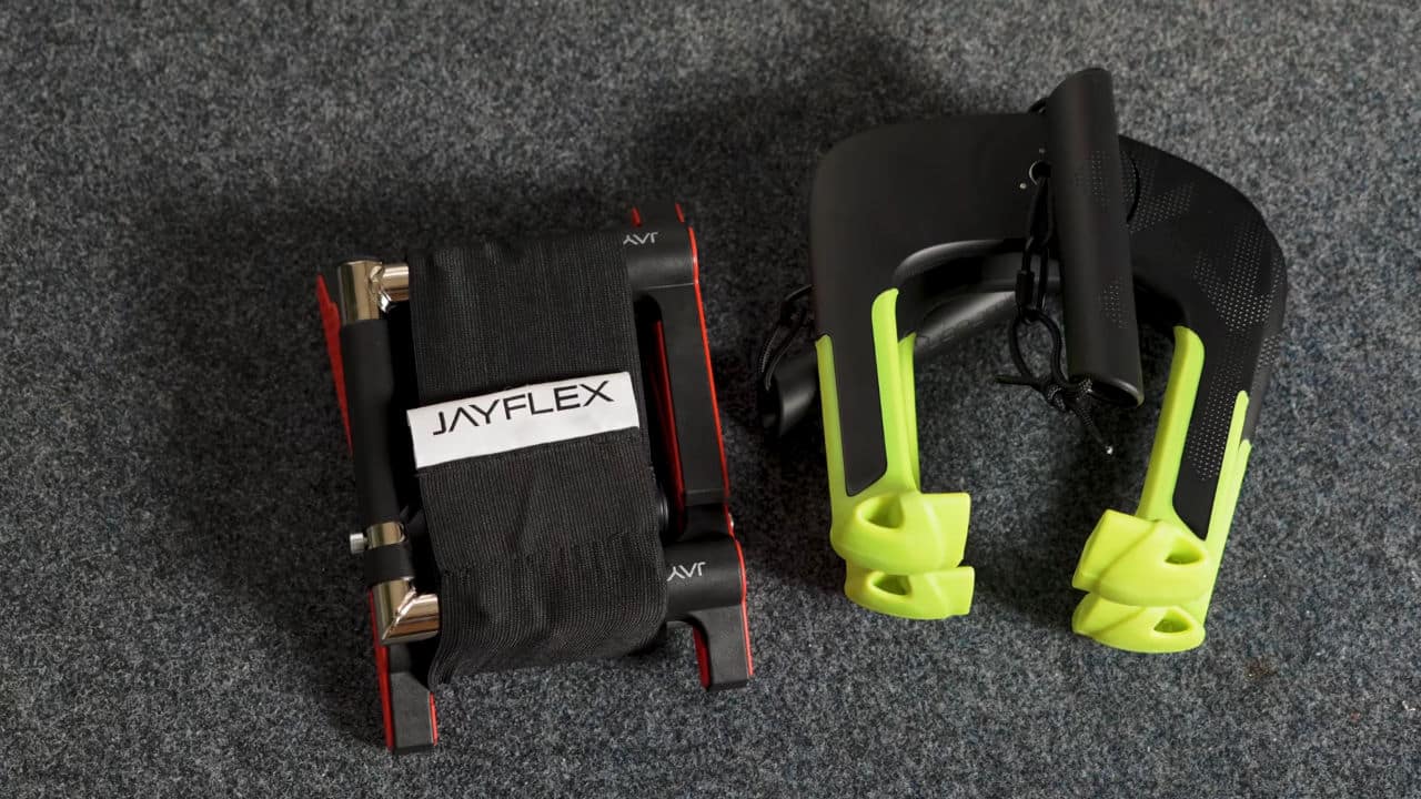 The Jayflex CrossGrips and Duonamic Eleviia door Pull-Up Handles in their folded form side by side on the floor.