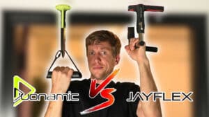 Man in black shirt hanging from two different door Pull-Up Handles, the Duonamic and Jayflex while looking incredulously at the camera.