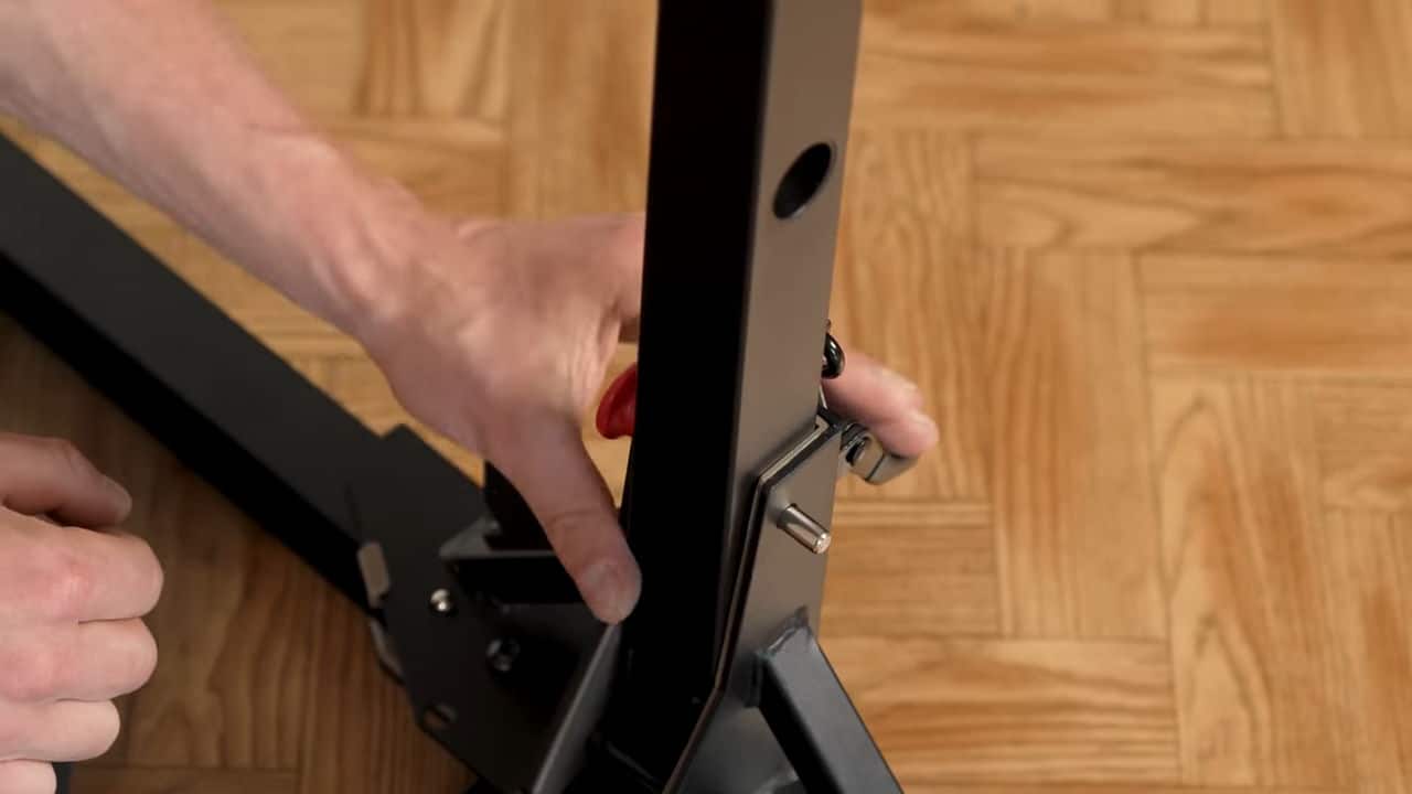 Man inserting one of the safety pins after setting up the bullbar 2.0 foldable pull-up bar.