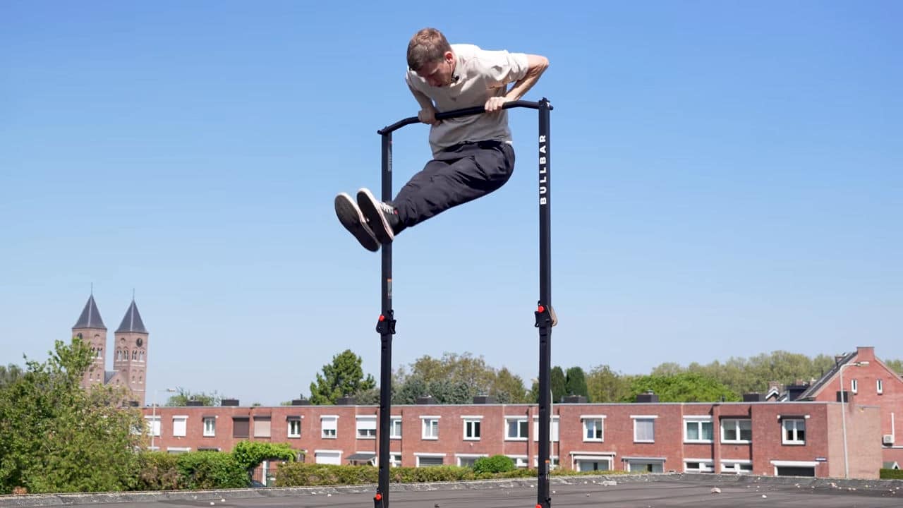 Man attempting a Muscle-Up on the bullbar 2.0 foldable pull-up bar but finding it too unstable to do safely.