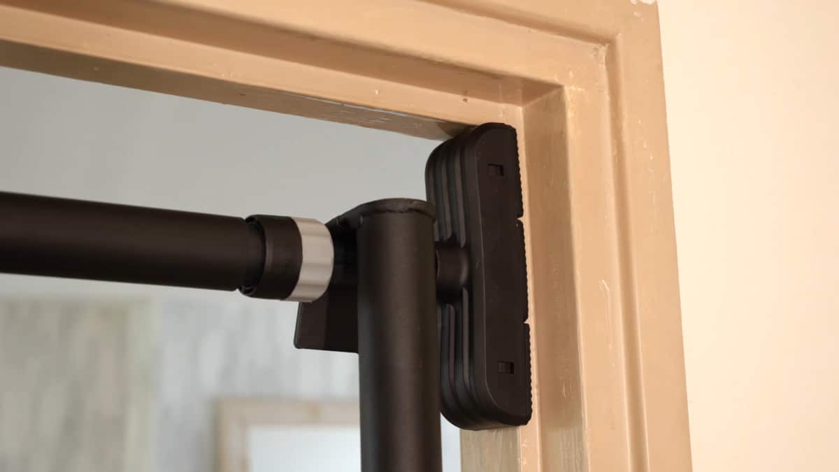 The Pullup & Dip Doorway Dip Bar hanging from the Pullup & Dip Telescopic Bar.