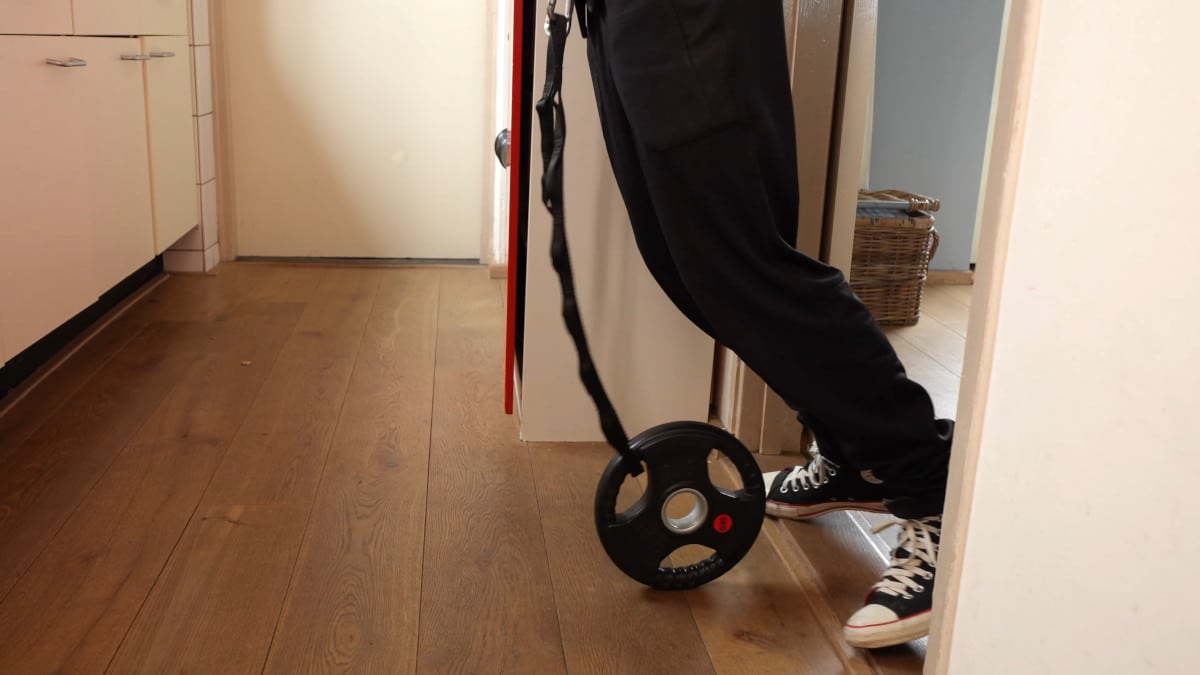 The weight on a Dip Belt touching the floor.