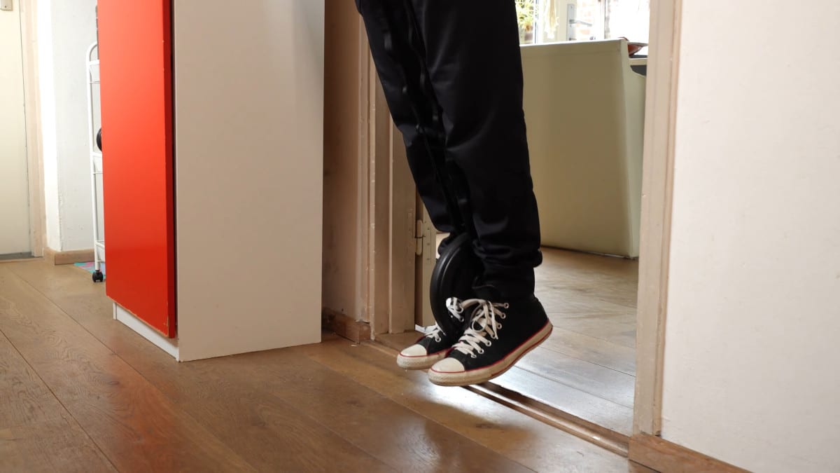 The weight on a Dip Belt remaining suspended off the floor.