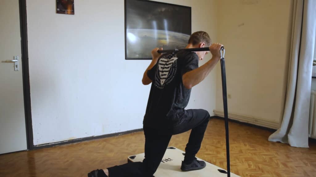 Man using Resistance Bands for exercises on the baseplate of a Fit Home Gym.