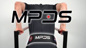 Man in black shirt doing heavy weighted dips while wearing the MPDS dip belt.