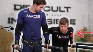 Two men in sportswear performing dips while wearing mpds elbow sleeves and other apparel of the same brand.