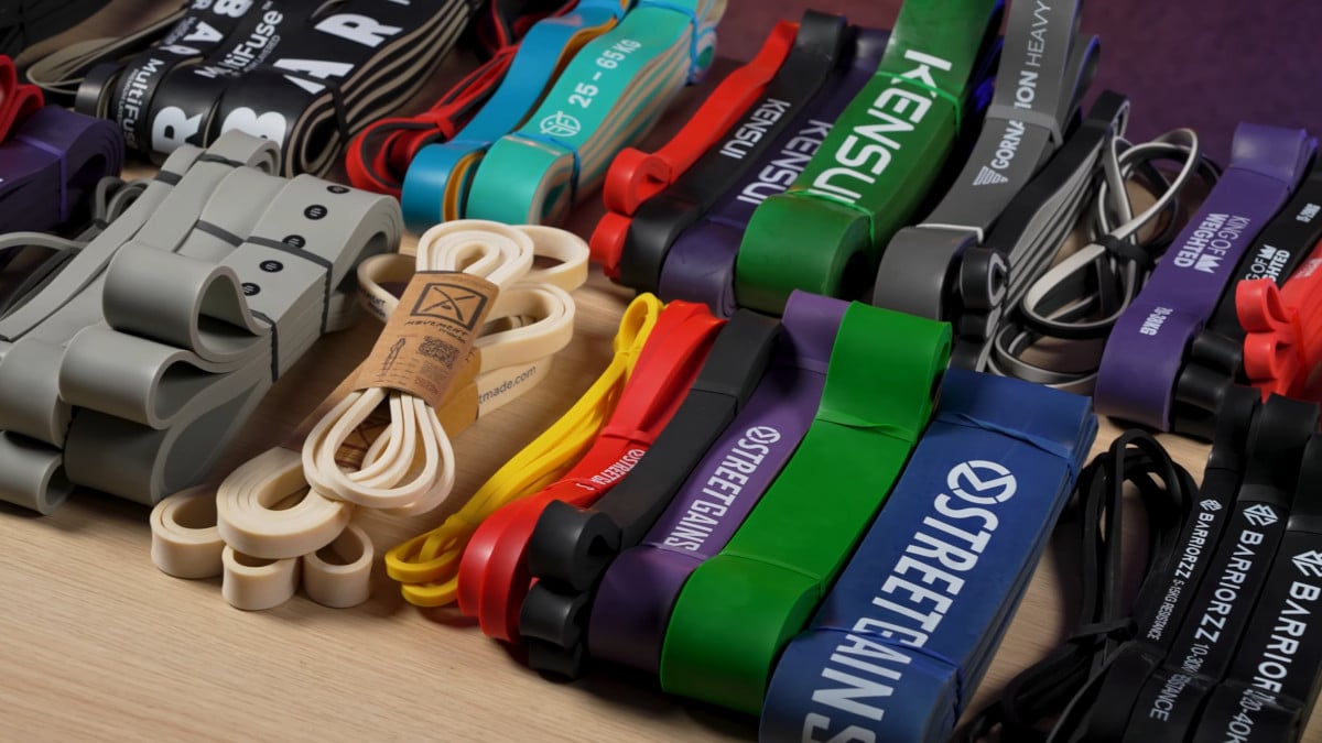 A large collection of colorful resistance bands arrayed on a table.