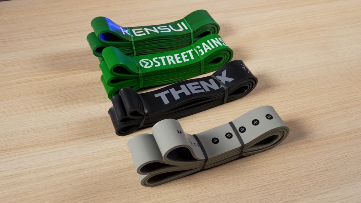 Four heavy resistance bands side by side from kensui, streetgains, thenx and marmati.