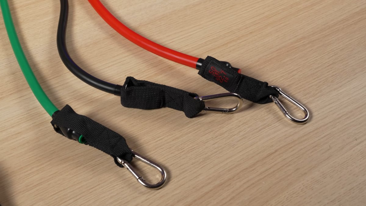 The ends of three tubular resistance bands, showing their carabiners.