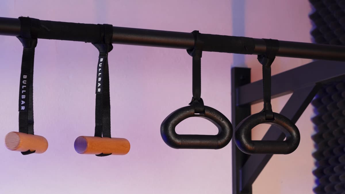 The bullbar pull-up handles and kensui 360 grips hanging side by side from their rotator straps from a pull-up bar.