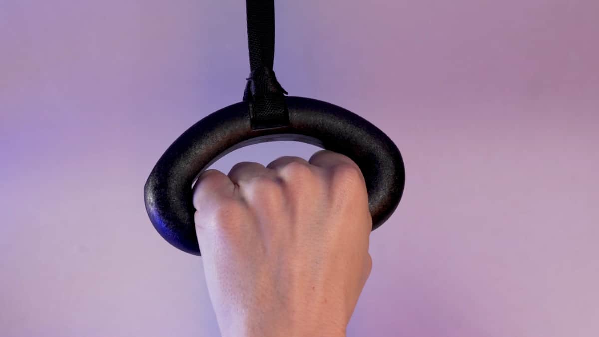 A man's hand just about fitting in a kensui 360 grips and finding that his hand just about fits in the opening.