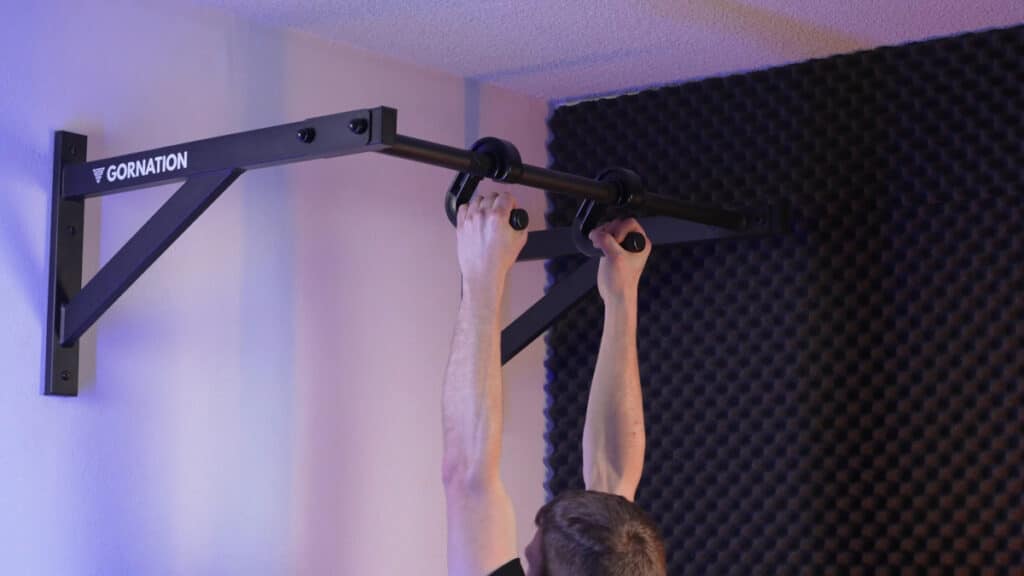 Man doing neutral grip pull-ups on the kensui swissies v1 pull-up handles haning from a gornation pull-up bar.