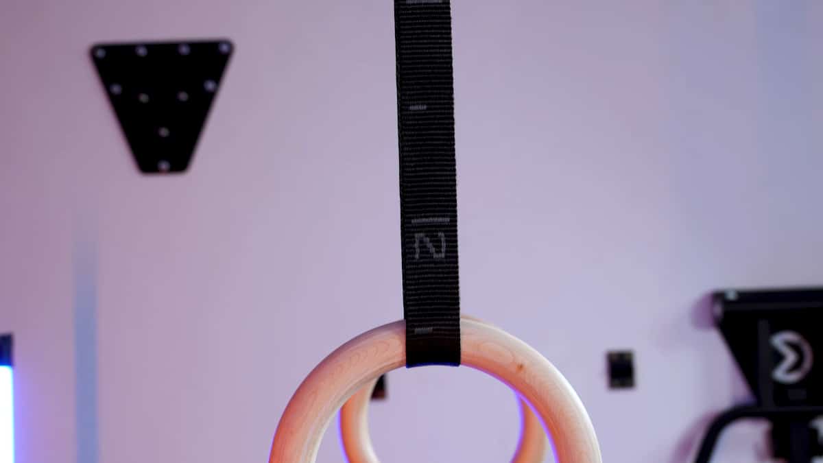 Close up of the straps on the gravity fitness gymnastic rings, showing the light grey on black design.