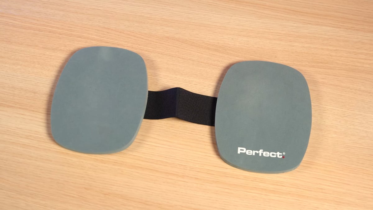 Above view of the grey Perfect Fitness knee pads, attached with a black strap.
