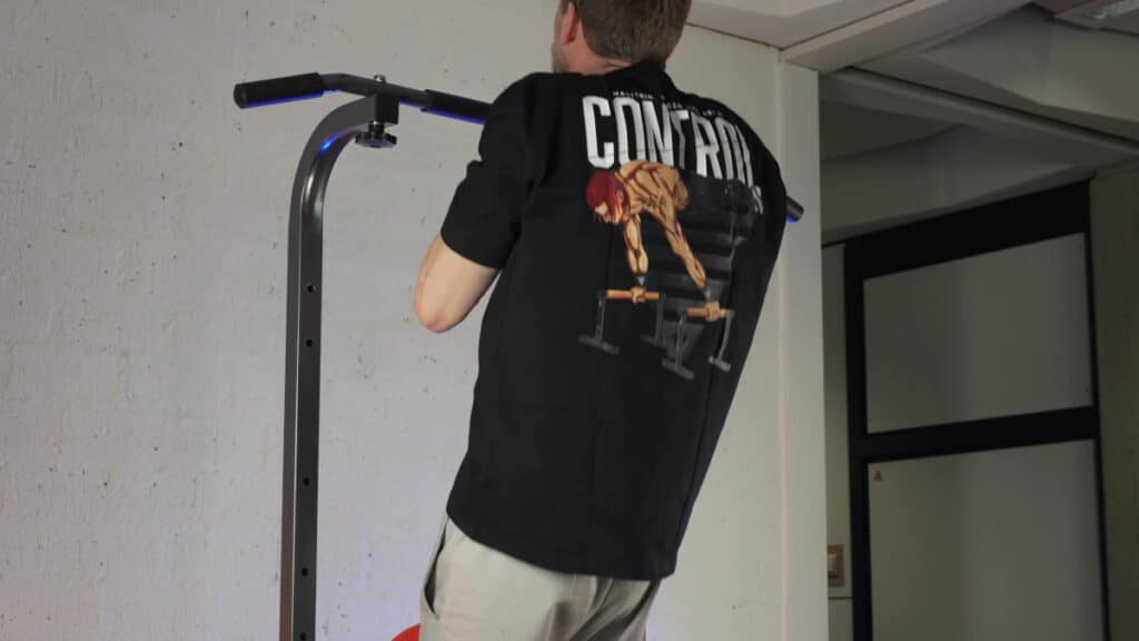 Man in black shirt doing narrow pull-ups on the relife power tower.