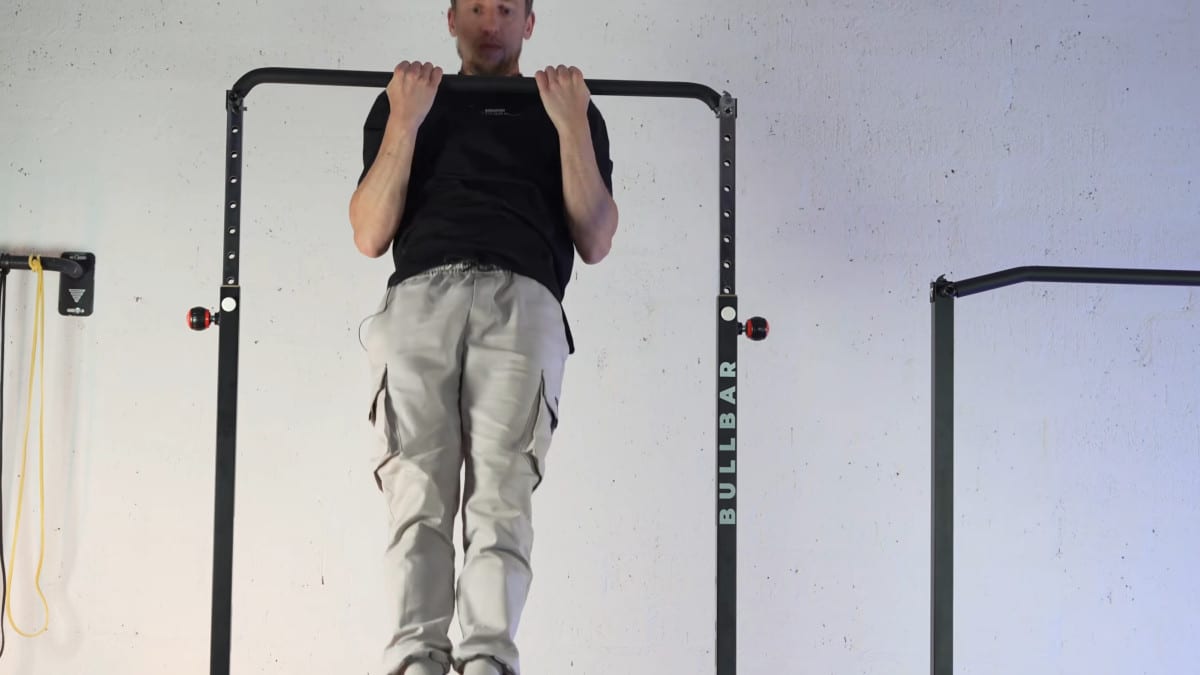 Man in black shirt doing chin-ups on a bullbar 2.0 extended pull-up bar.