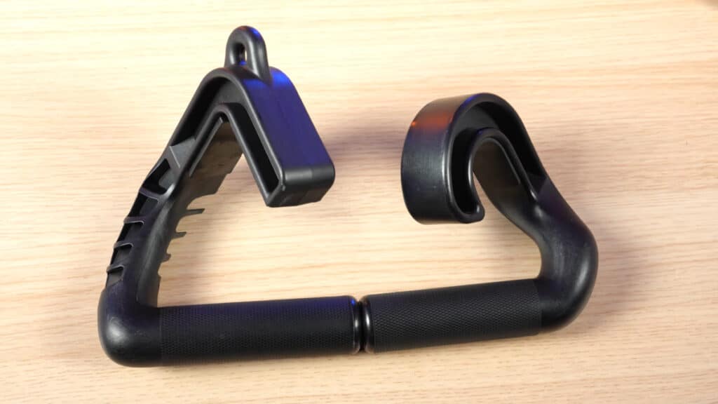 Two kensui swissies, a v1 sp and v2 sp lying side by side on a wooden table, showing the rounded hook on the v1 and the wider angular hook on the v2.