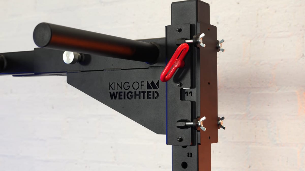 View of the safety pin and fastening assembly where the king of weighted adjustable dip bar is fastened to the dip station.