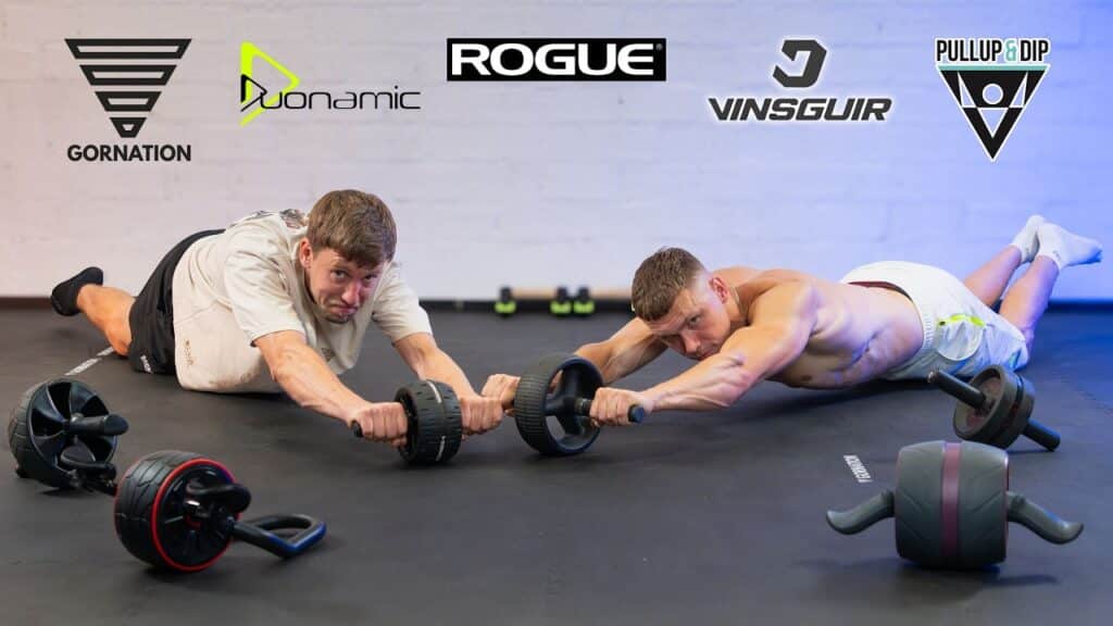 Two athletic men doing ab rollouts on an assortment of ab rollers from various brands while looking questioningly at the viewer.