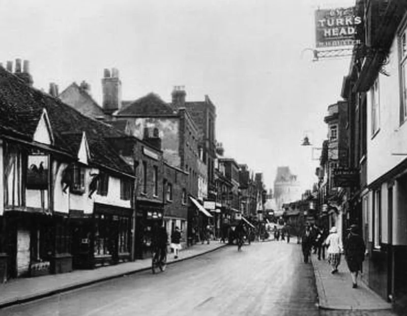 A black and white photo of a street scene from 1935