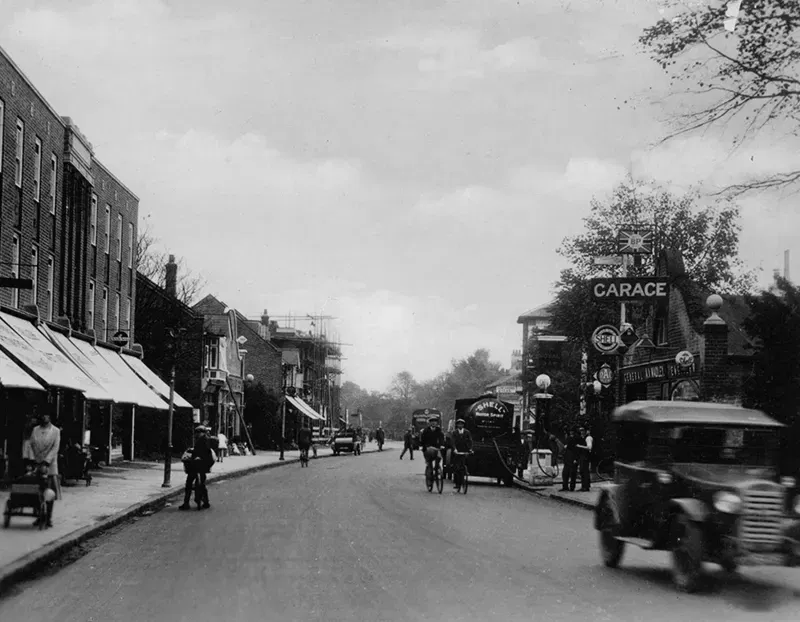A black and white photo of a street scene from 1940