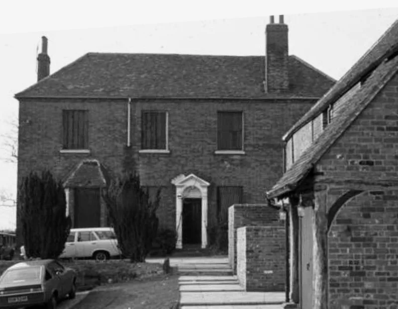 A photo of a detached brick building
