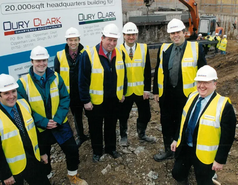 7 men in hard hats and hi-vis vets on a building site for Oury Clark headquarters